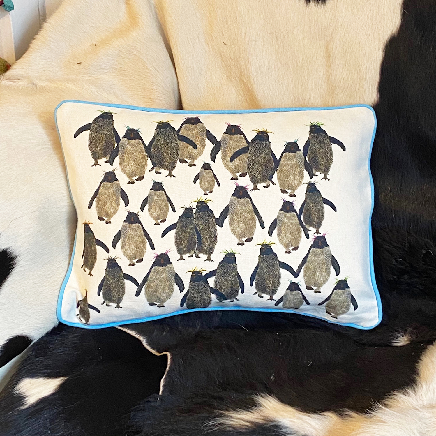 Rockhopper repeat cushion small with blue piping on sofa A