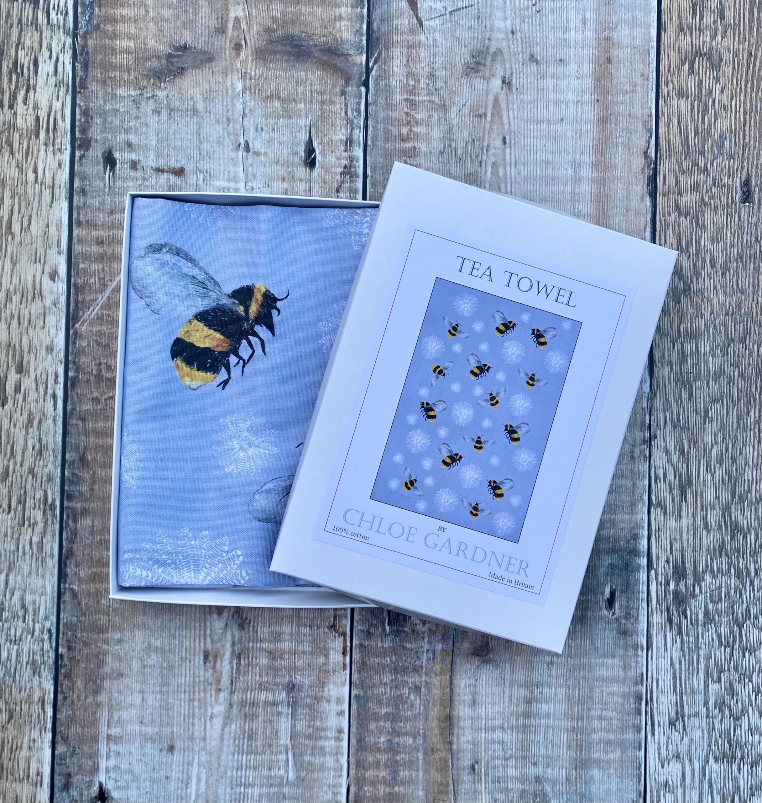 A GIFT BOXED TEA TOWEL - BEES & FEATHER FLOWERS ON GREY
