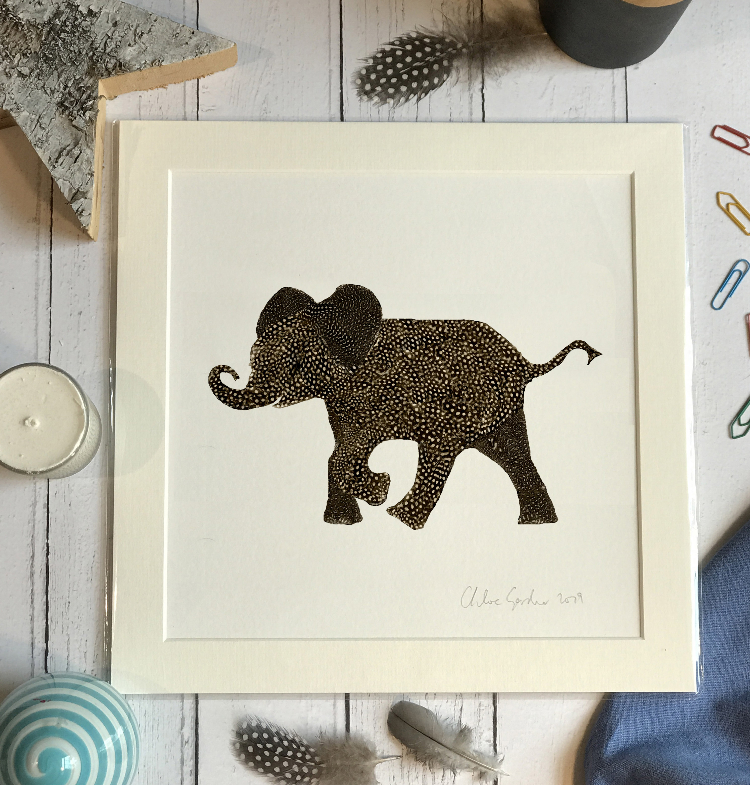 Unframed Print - Square in a mount and bag for 12 inch frame - feather baby elephant with a curved trunk  (Avail:1 02/24)