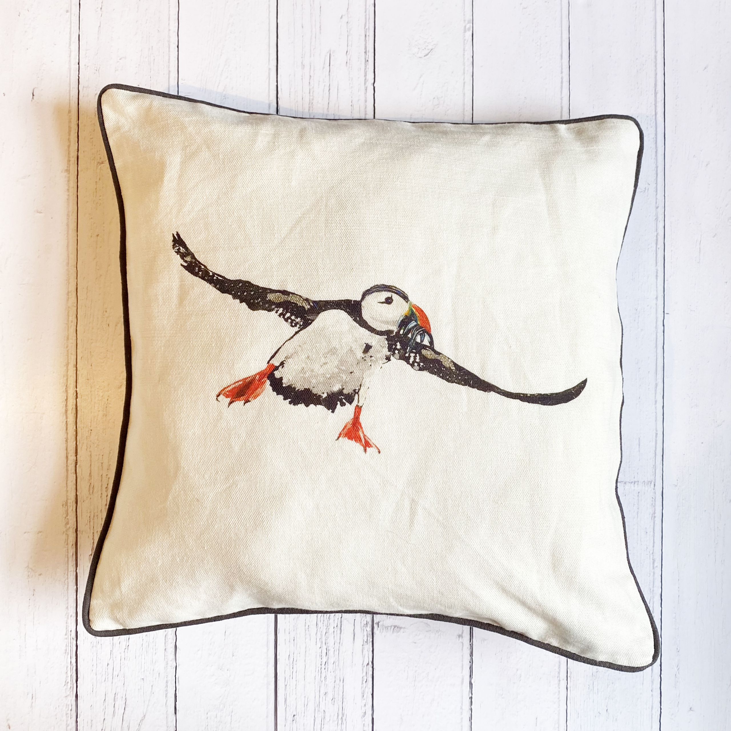 SQUARE CUSHION - Puffin Flying square cushion (Charcoal Piping) (Avail R5F29; 04/25)