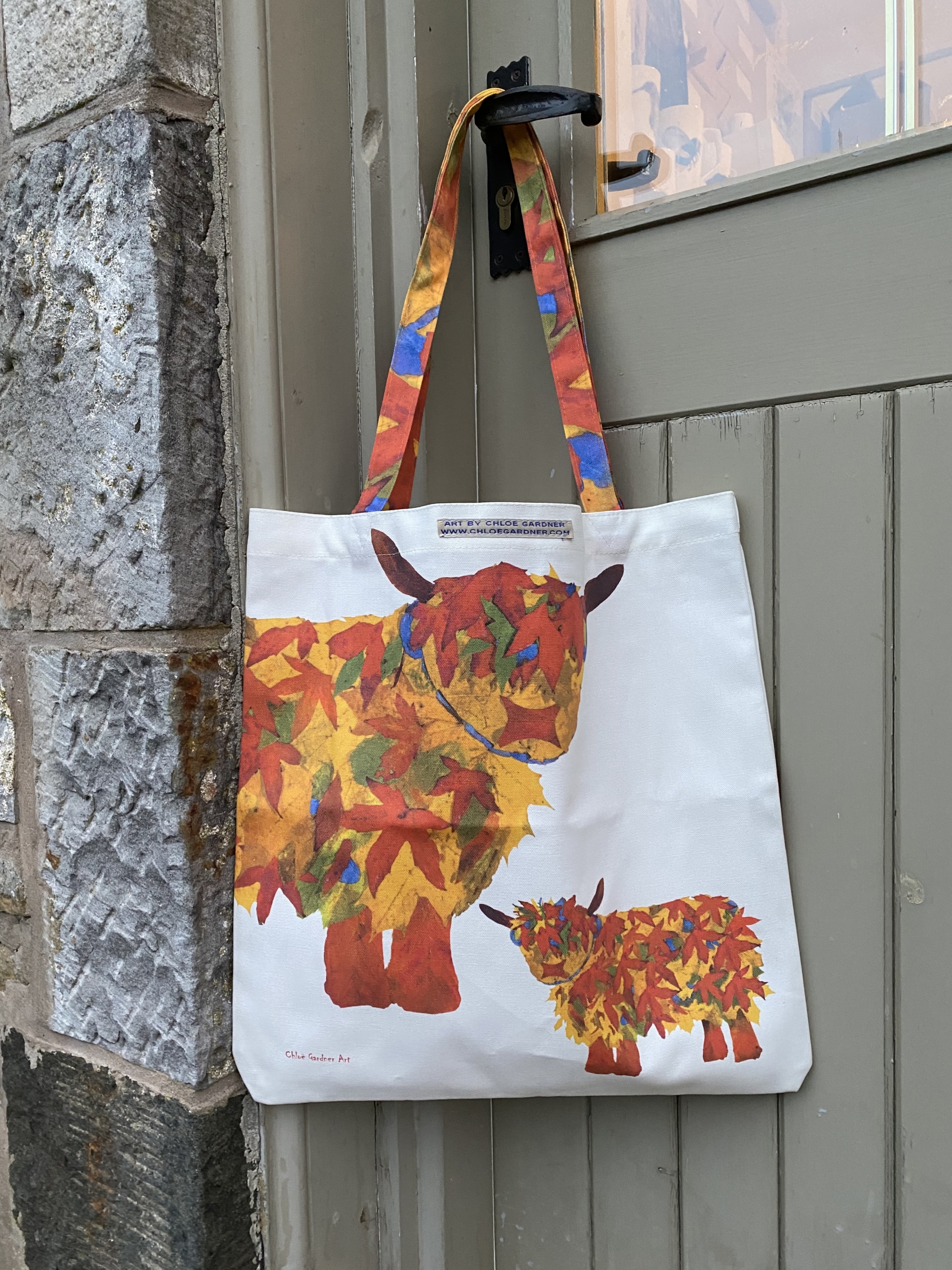Colourful Leaf Highland Cow Shopper Bag with Orange Red and Green Autumn leaves forming a Cow design, printed onto a large tote style cotton Canvas bag