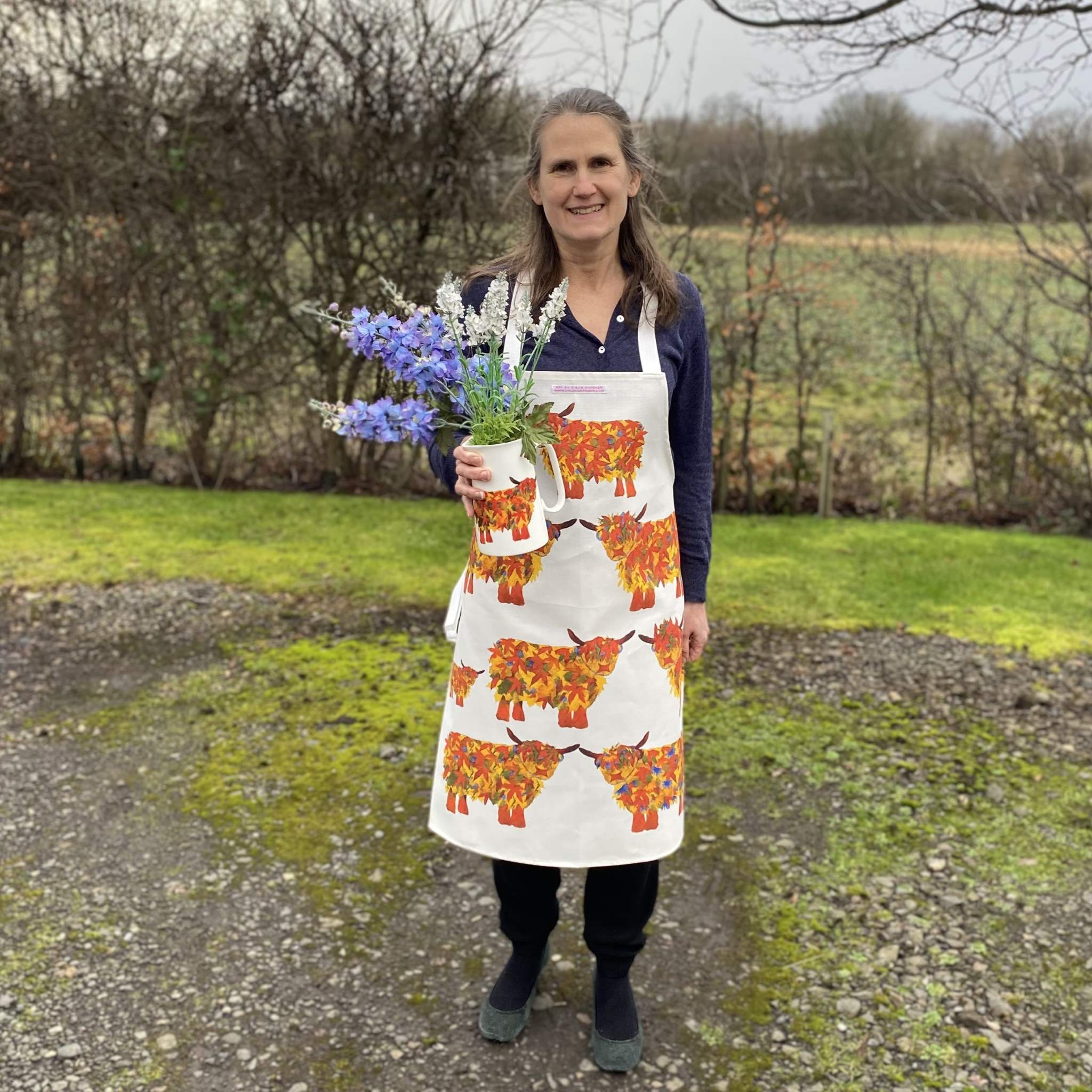 Leaf Cow Aprorn worn by chloe holding leaf jug