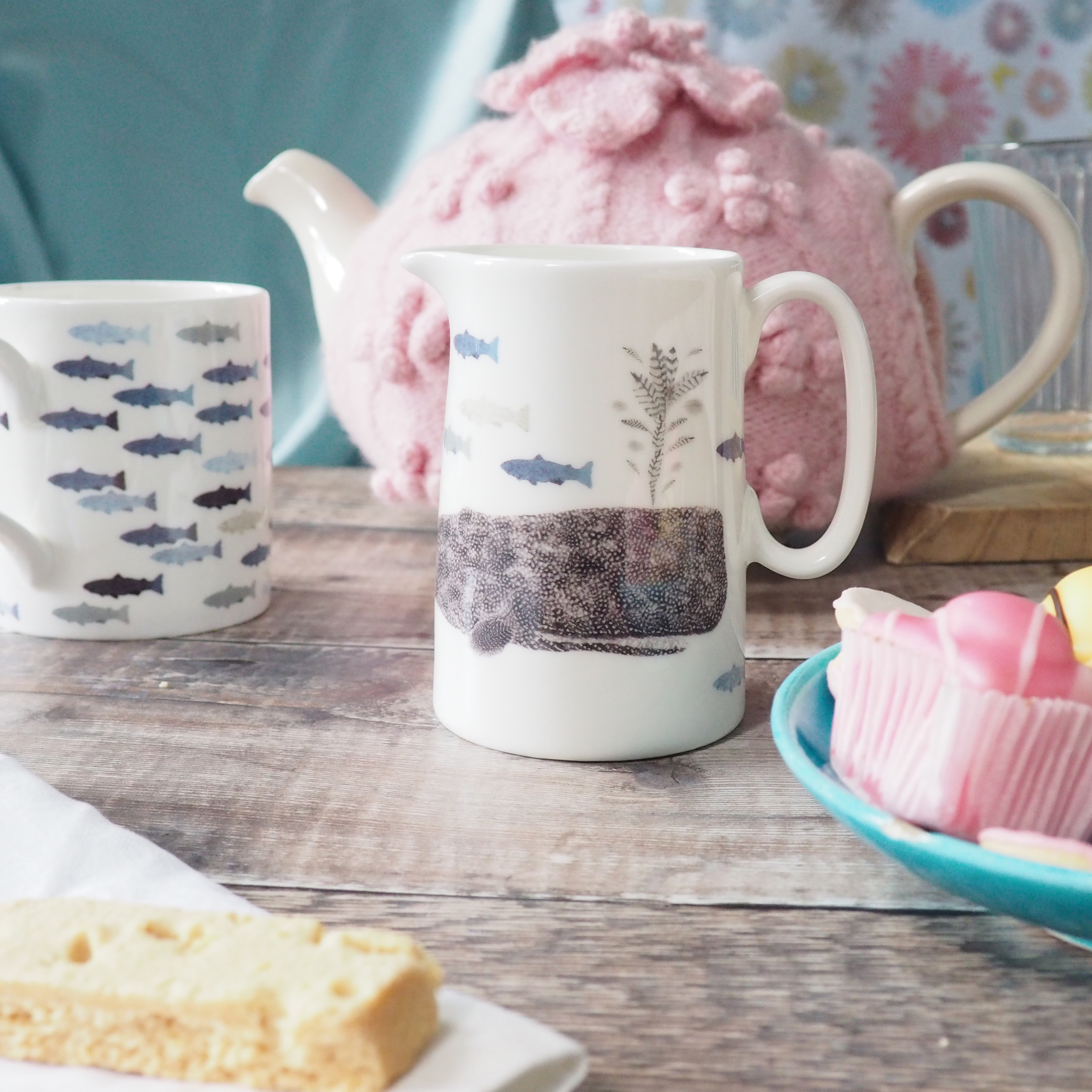 Whale Jug in Half Pint Size made by Chloe Gardner on table set with teapot, matching Jug and afternoon cakes